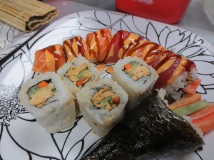 Dragon roll, california temaki, and a salmon inside out roll